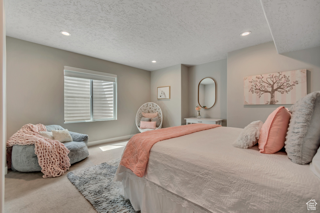 Carpeted bedroom featuring recessed lighting and a textured ceiling