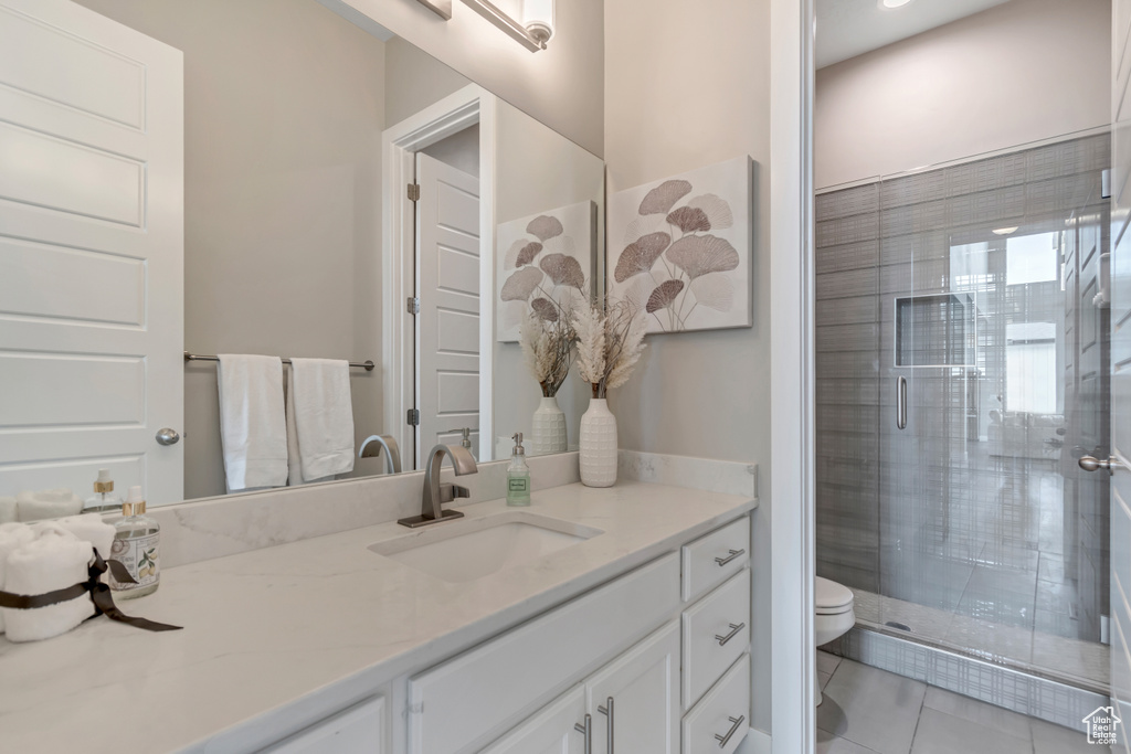 Full bath with vanity, tile patterned floors, and a stall shower