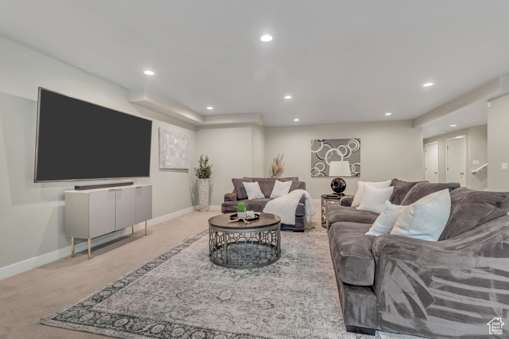 Living area with recessed lighting and carpet floors