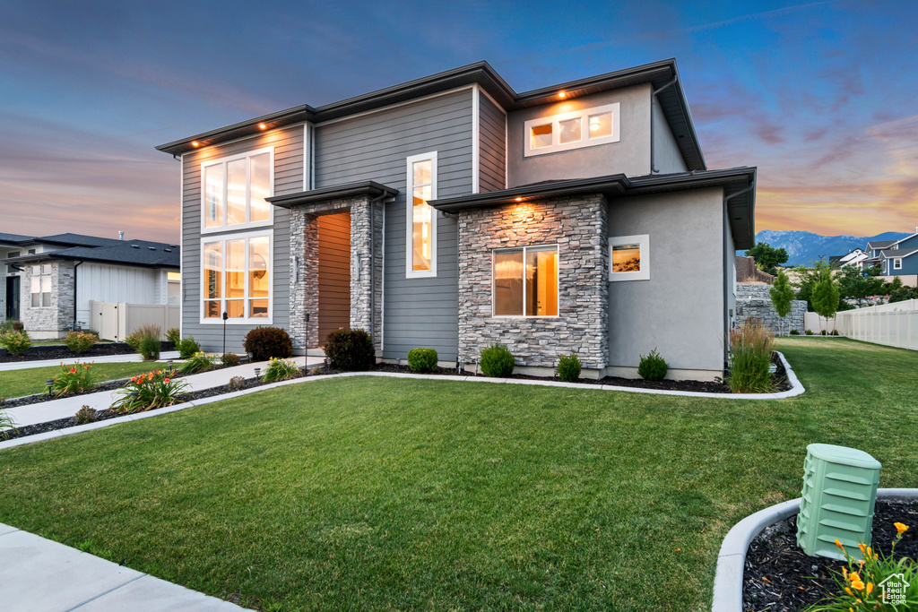 View of front of property featuring stone siding and stucco siding
