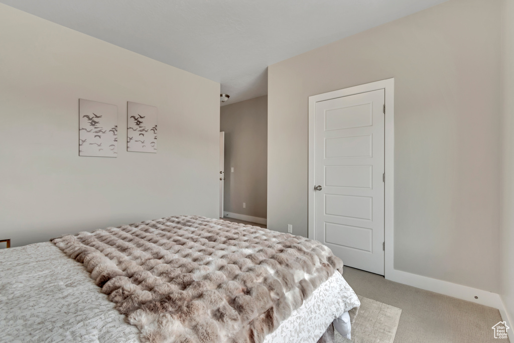 Carpeted bedroom with baseboards