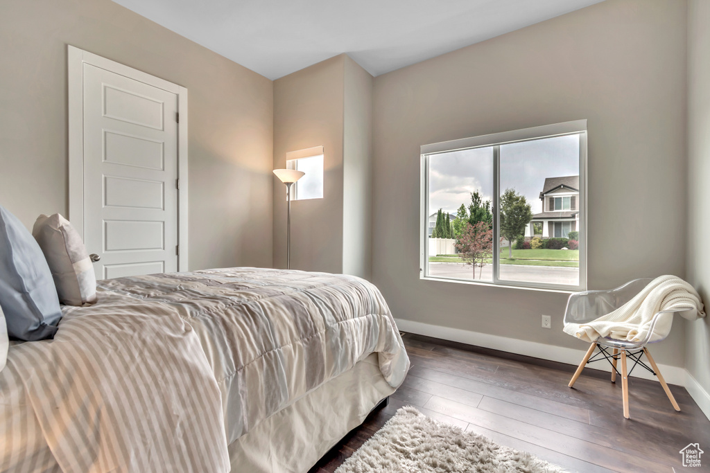 Bedroom with baseboards and hardwood / wood-style floors