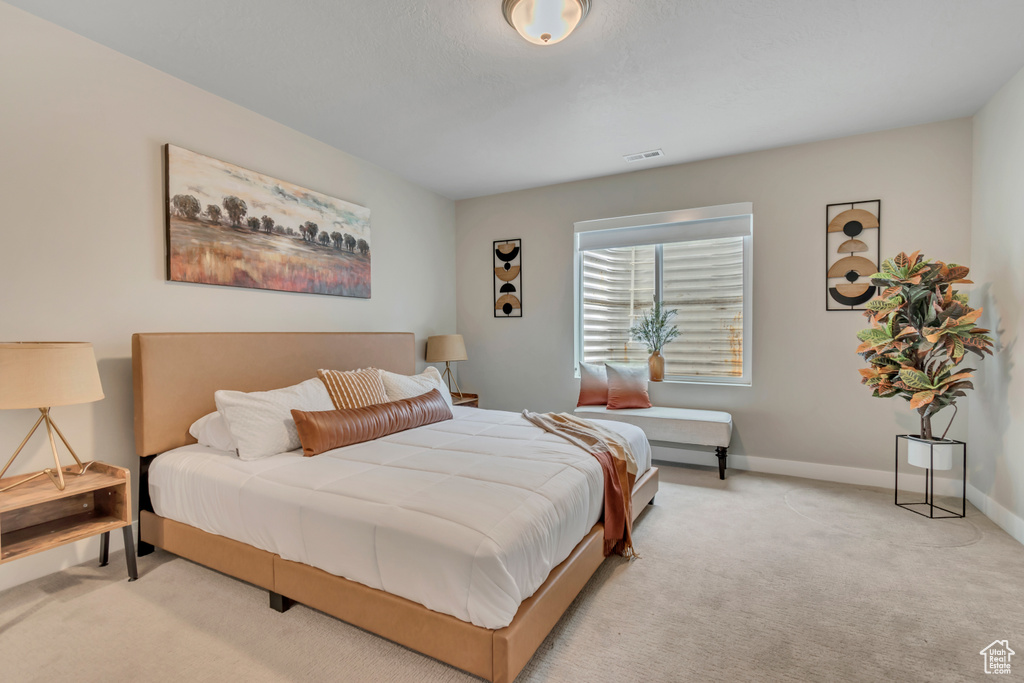 Carpeted bedroom with baseboards