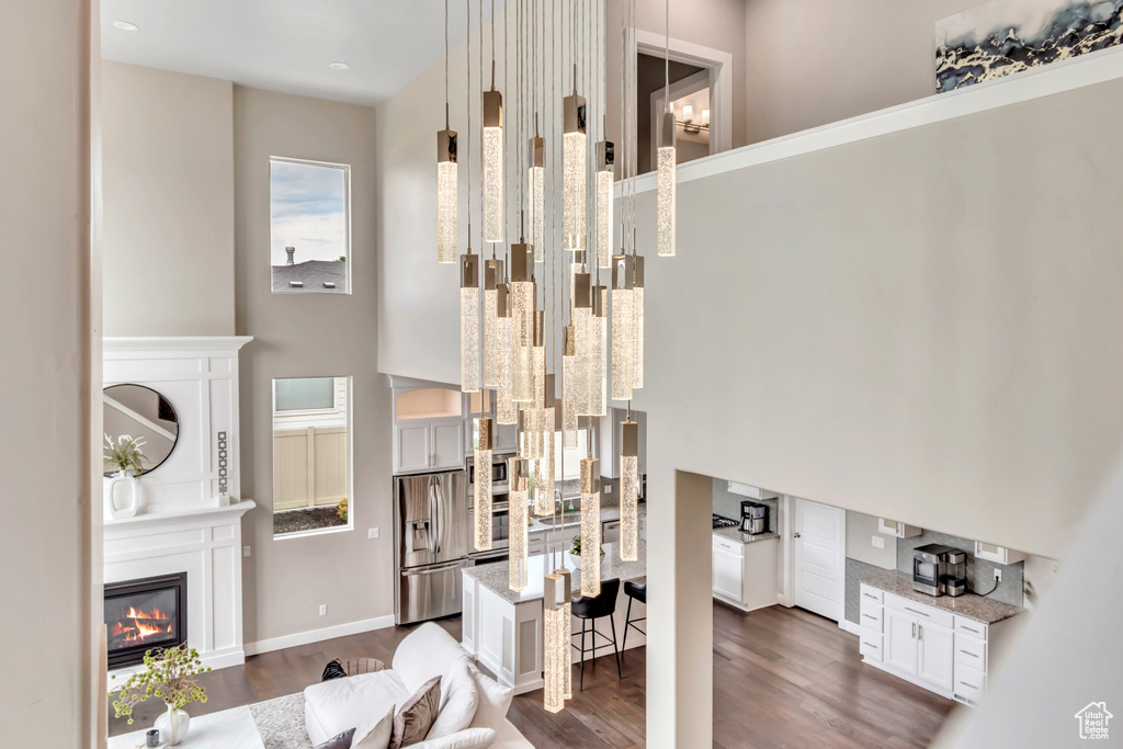 Living area with dark wood-style floors and a glass covered fireplace