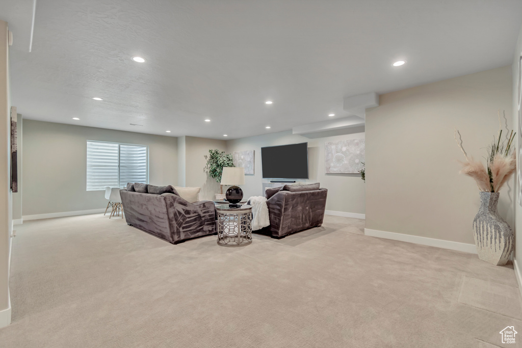 Living room featuring light colored carpet and recessed lighting