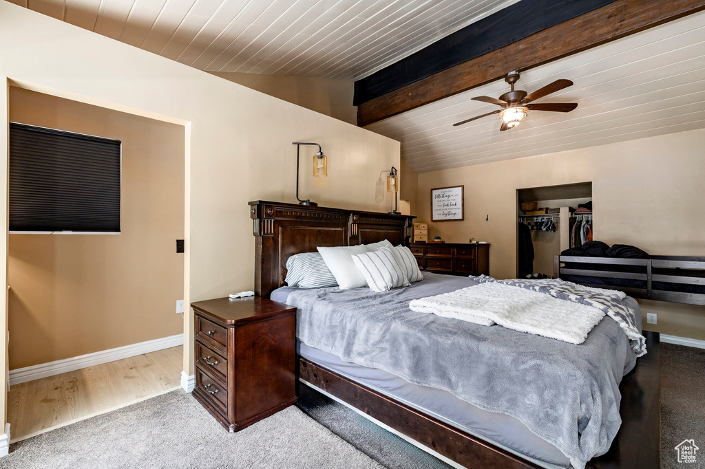 Bedroom with carpet floors, wood ceiling, a ceiling fan, and a closet