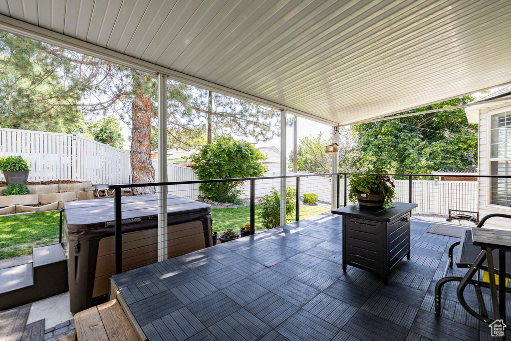 Sunroom featuring a hot tub