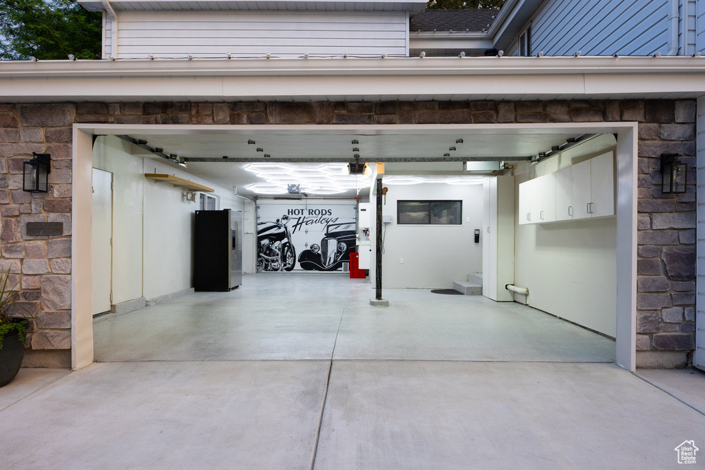Garage featuring concrete driveway