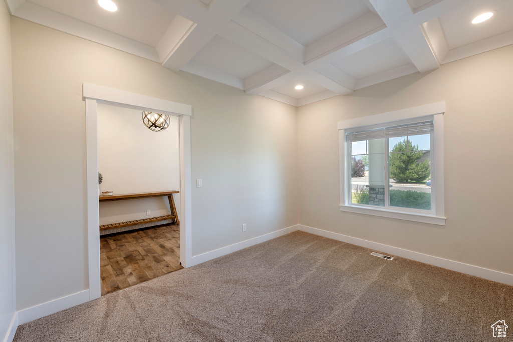 Carpeted empty room with coffered ceiling, beam ceiling, and recessed lighting