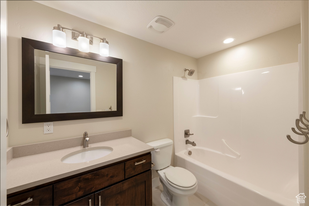 Full bathroom featuring vanity, shower / tub combination, and recessed lighting