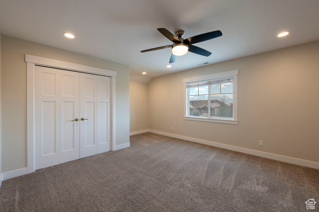 Unfurnished bedroom with carpet flooring, recessed lighting, a closet, and ceiling fan