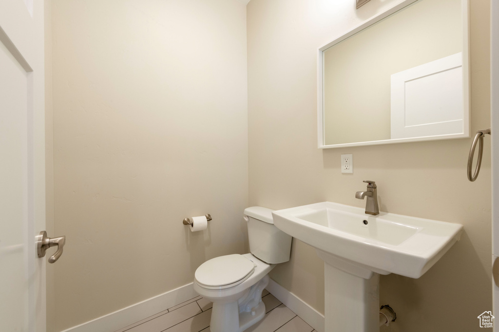 Bathroom with toilet and tile patterned flooring
