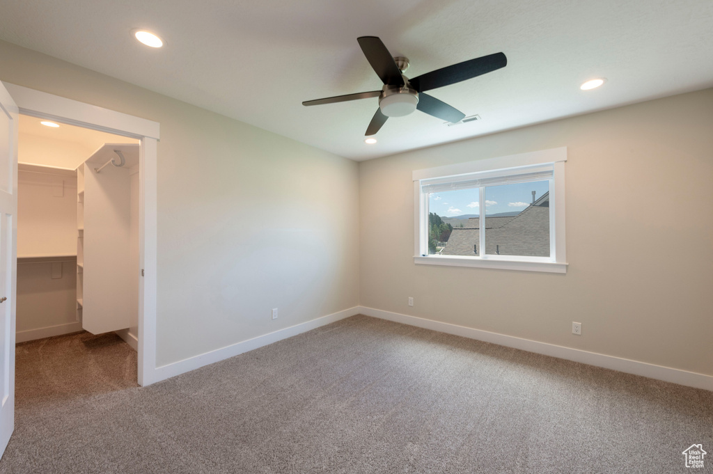 Unfurnished room featuring carpet flooring, a ceiling fan, and recessed lighting