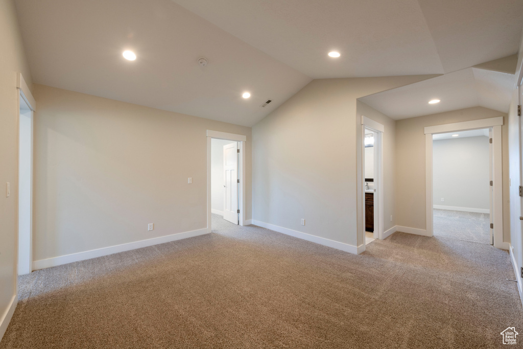Spare room with lofted ceiling, carpet floors, and recessed lighting