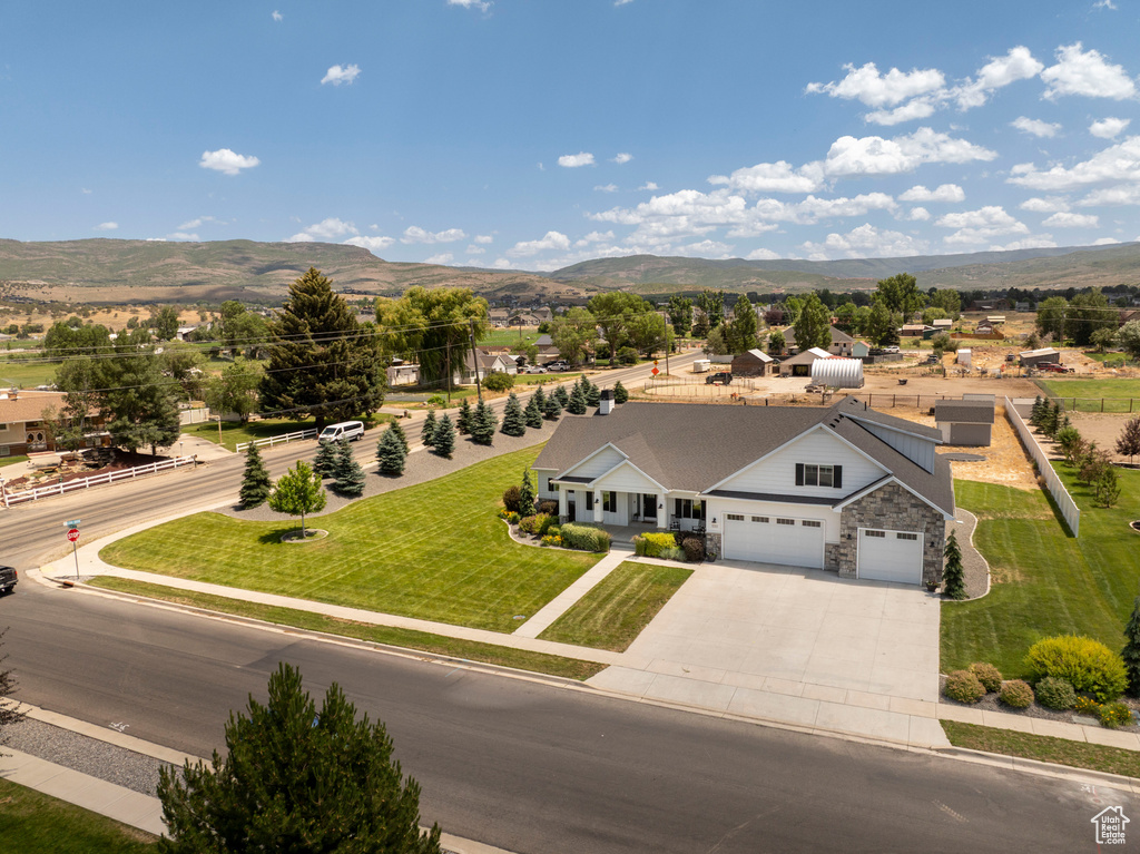 Aerial view of property and surrounding area with mountains