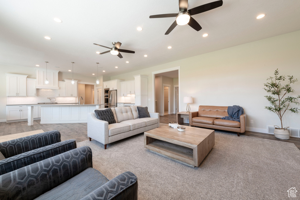 Living area with a ceiling fan and recessed lighting