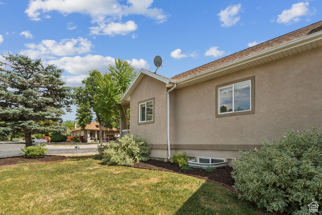 View of side of home featuring stucco siding
