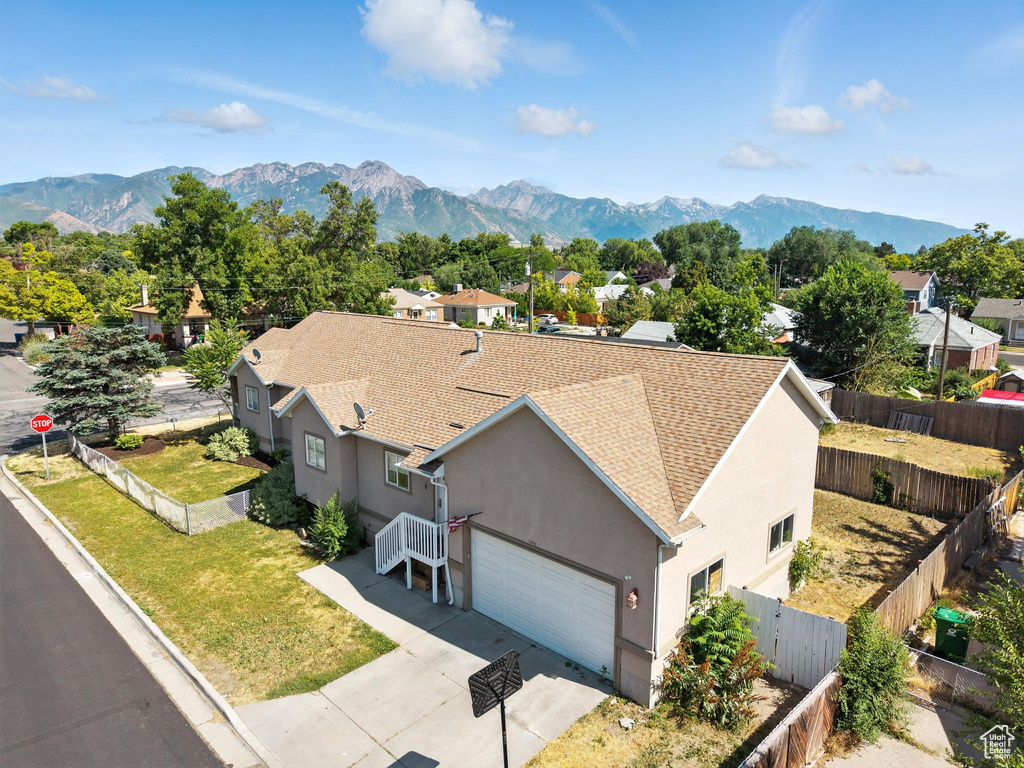 Aerial perspective of suburban area featuring a mountain backdrop