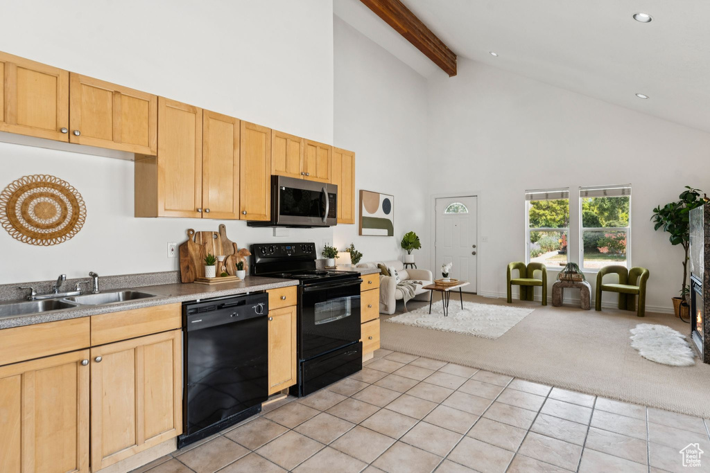 Kitchen featuring black appliances, high vaulted ceiling, light carpet, beamed ceiling, and light tile patterned flooring