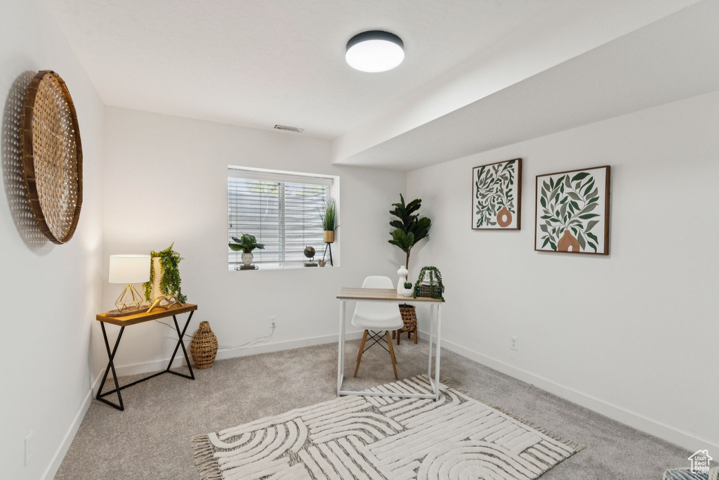 Home office with carpet flooring and baseboards