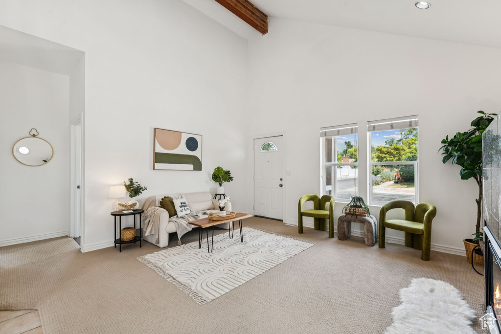 Carpeted living area featuring high vaulted ceiling, beam ceiling, and recessed lighting