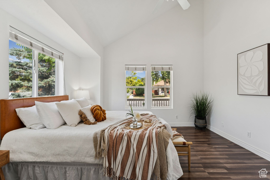 Bedroom featuring dark wood-style flooring, high vaulted ceiling, and ceiling fan