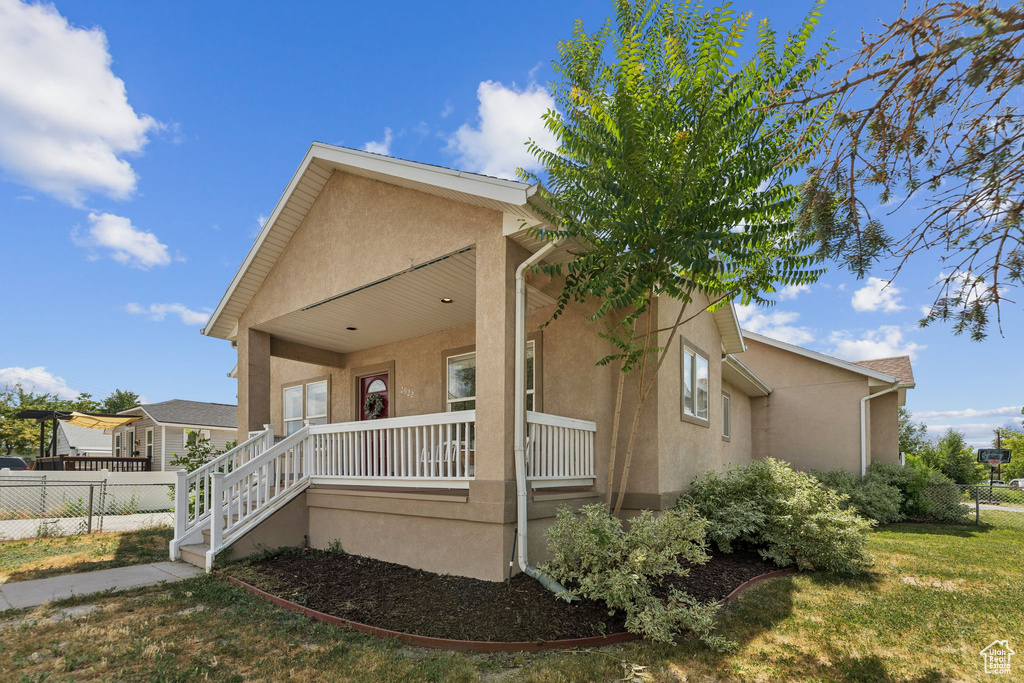 View of front of property with stucco siding and a porch