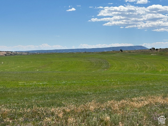 View of mountain background featuring rural landscape