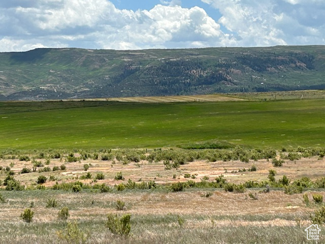 View of mountain background featuring rural landscape