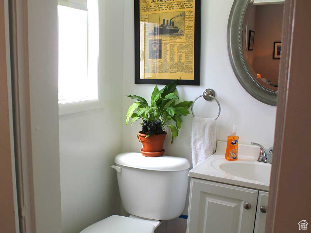 Half bathroom with toilet and vanity