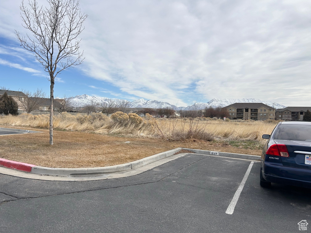 Uncovered parking lot featuring a mountain view