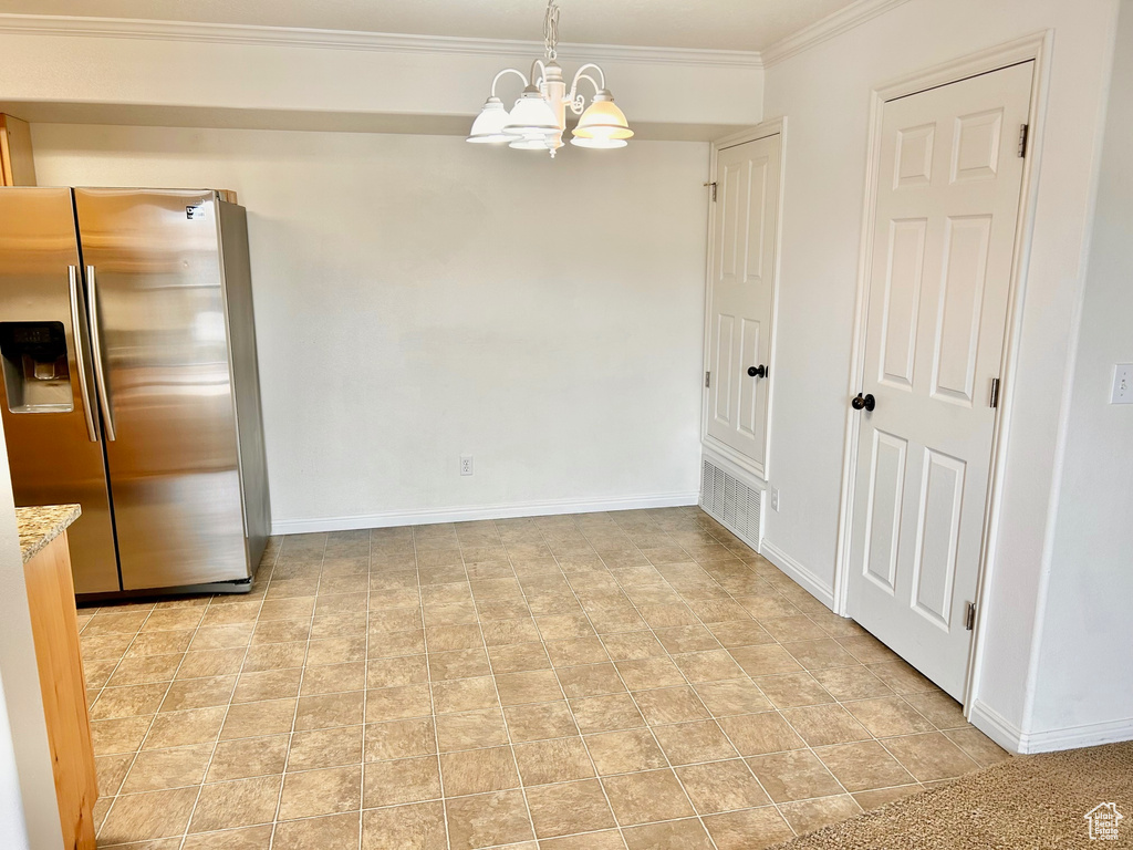 Unfurnished dining area with a chandelier and ornamental molding