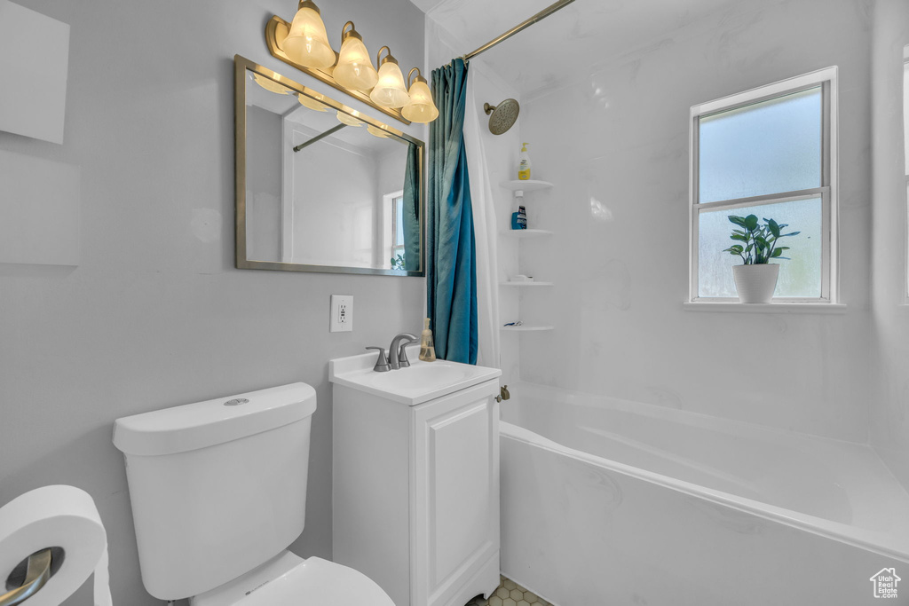 Full bath featuring shower / bath combo with shower curtain and vanity
