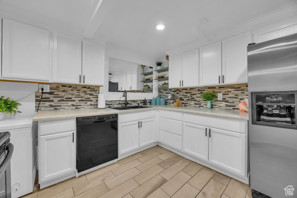 Kitchen featuring stainless steel fridge with ice dispenser, dishwasher, tasteful backsplash, white cabinets, and recessed lighting