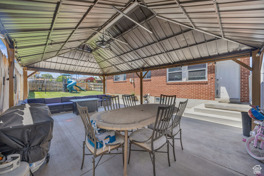 View of patio / terrace with a playground, area for grilling, a gazebo, and outdoor dining space