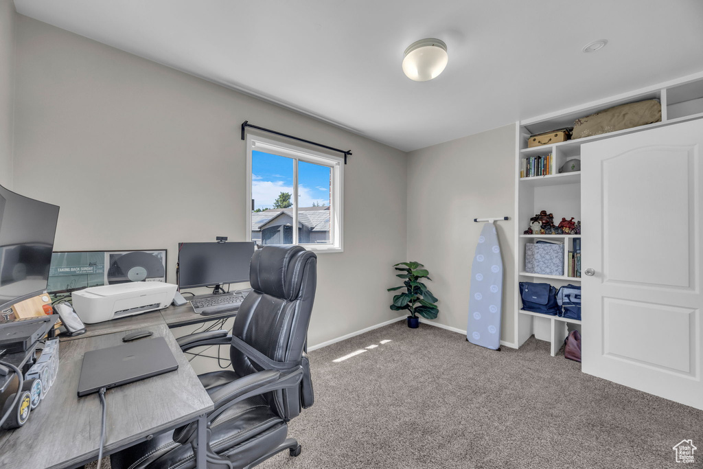 Carpeted office featuring baseboards