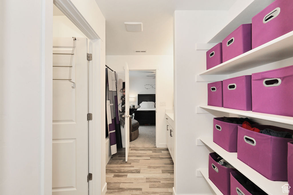 Hallway with light wood-style flooring