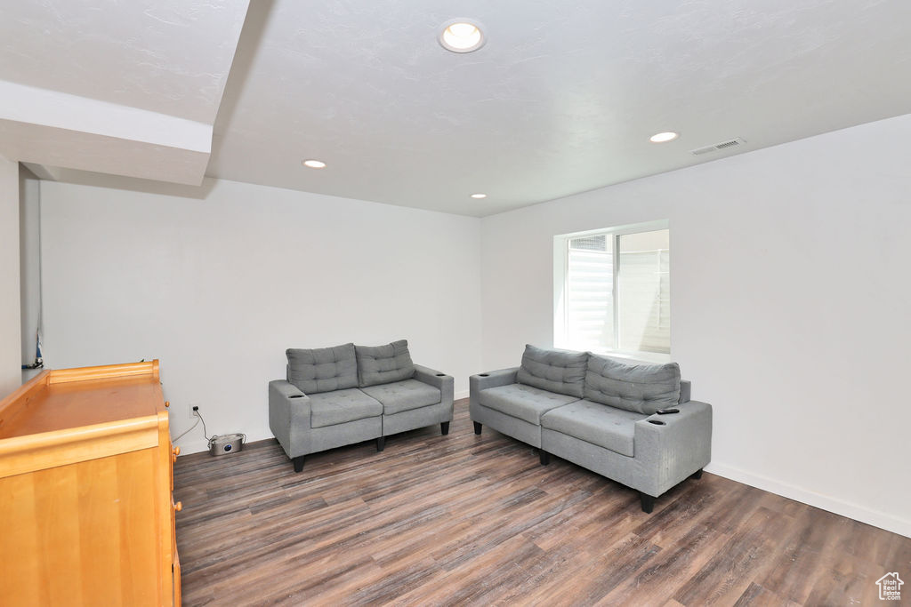 Living room with wood finished floors and recessed lighting