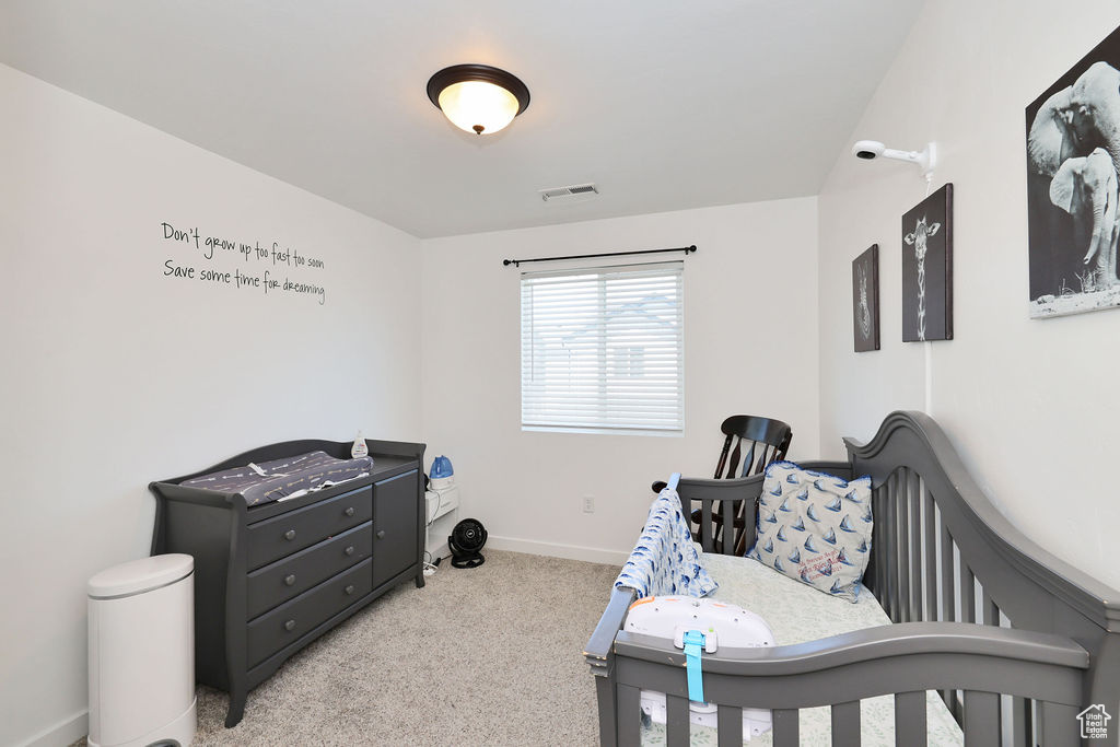 Bedroom with carpet floors and baseboards