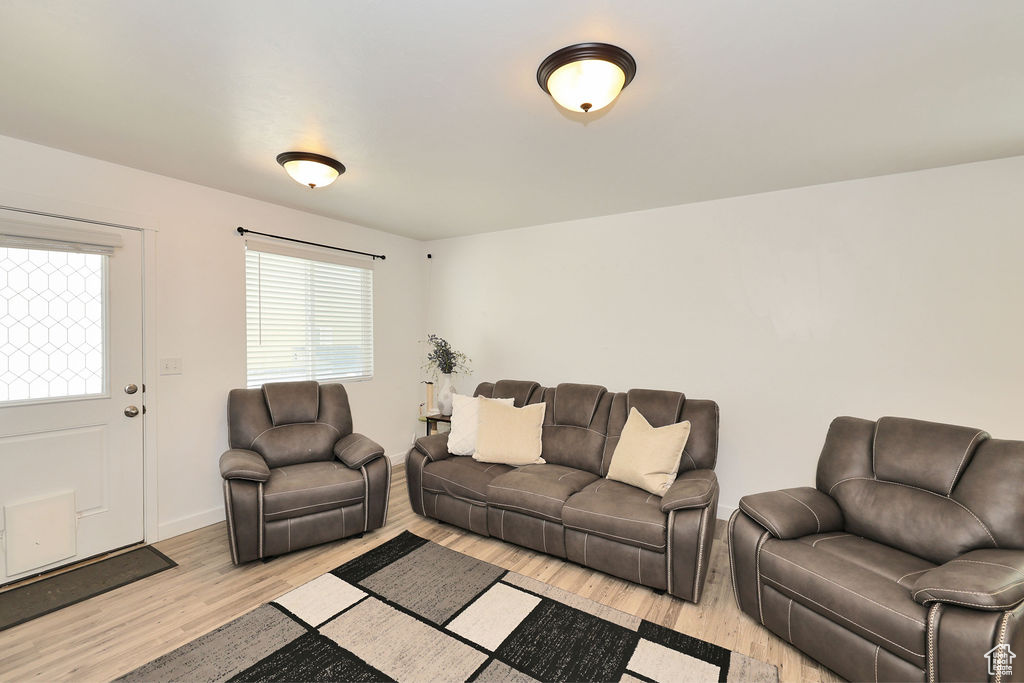 Living room featuring light wood-style flooring and baseboards