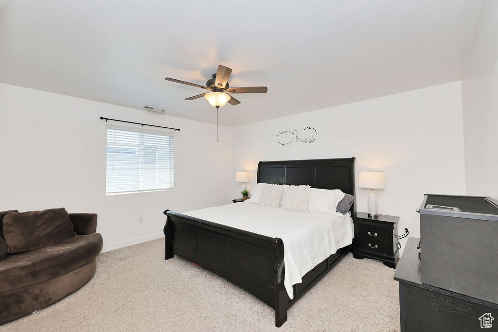 Bedroom featuring light carpet and a ceiling fan
