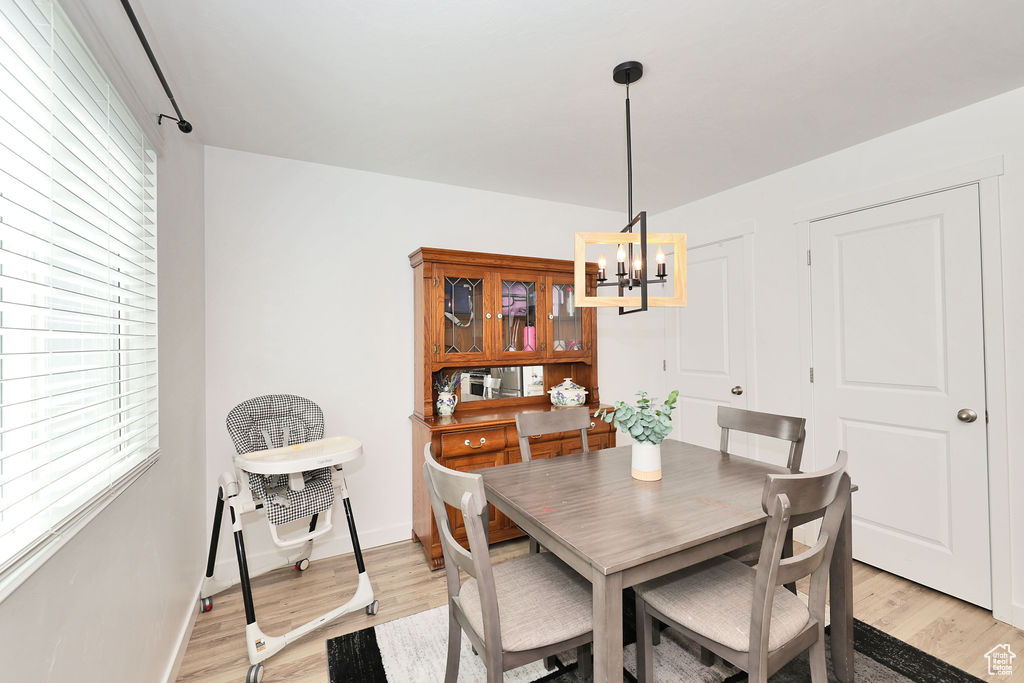 Dining area featuring a chandelier and light wood-style floors
