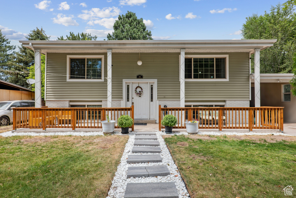 Bi-level home featuring a front yard and a porch