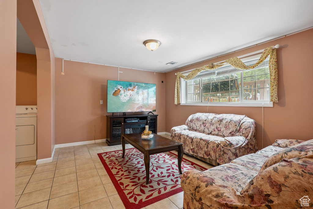 Living area with washer / dryer and tile patterned floors