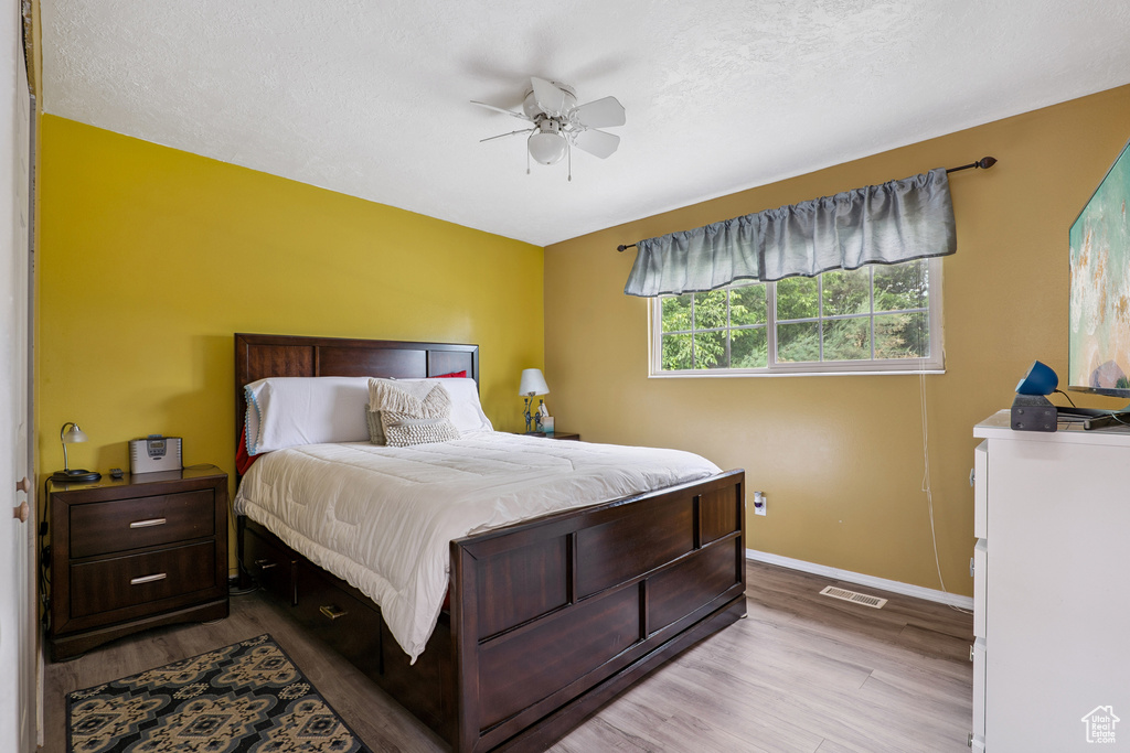 Bedroom with wood finished floors and a ceiling fan