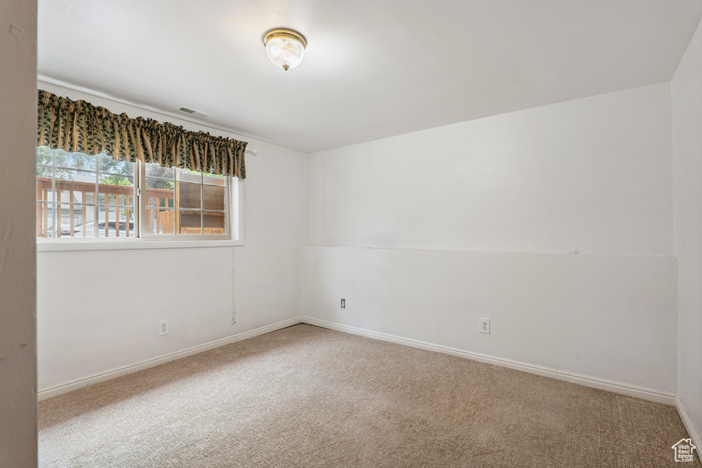 Empty room with carpet floors and baseboards