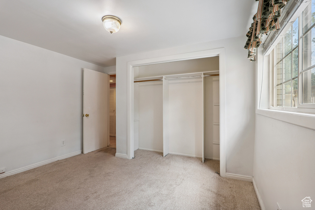 Unfurnished bedroom featuring carpet floors and a closet
