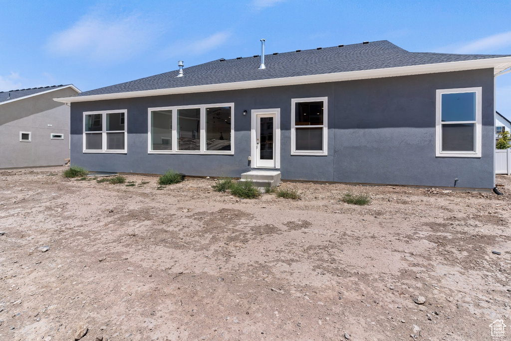 Rear view of property with stucco siding