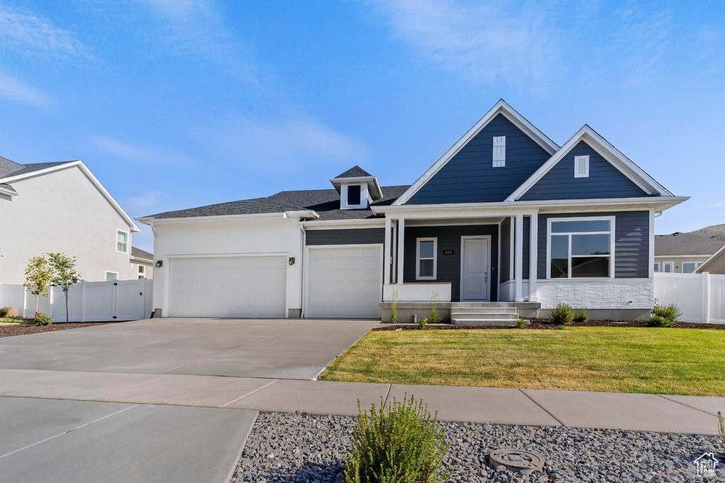 View of front of property with a garage and driveway