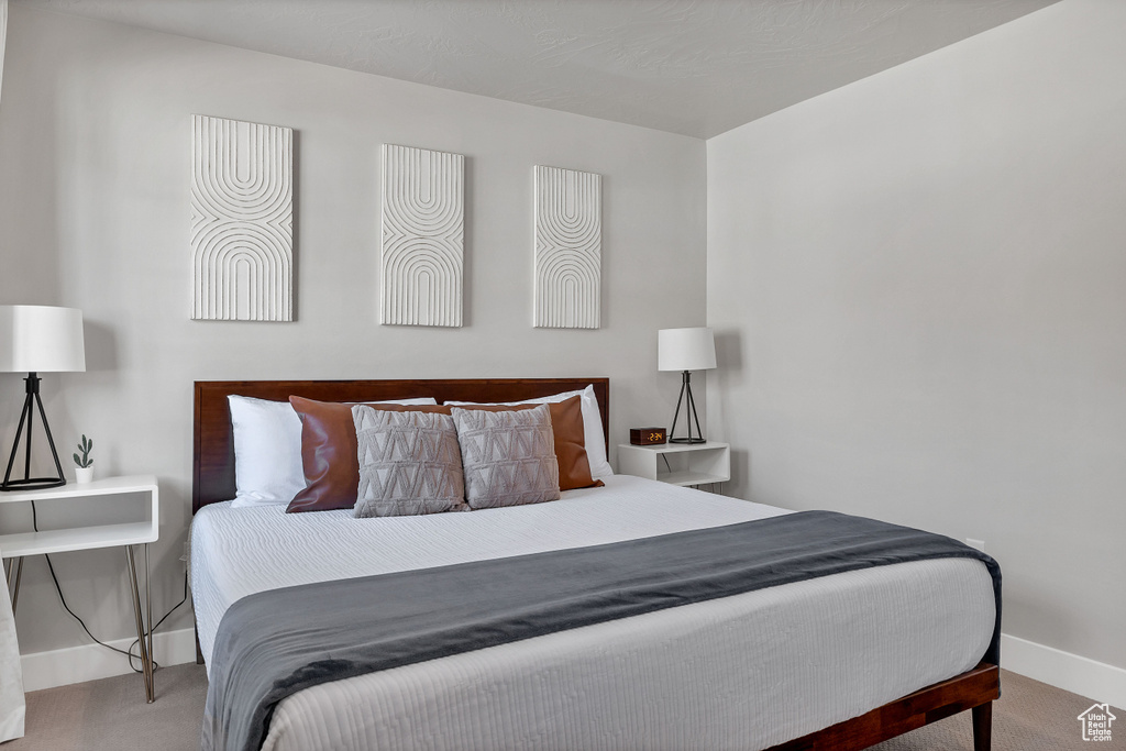Carpeted bedroom featuring baseboards